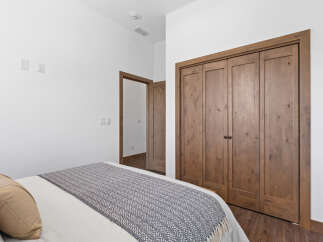 This bedroom features a cozy bed with a patterned throw, perfect for relaxation.