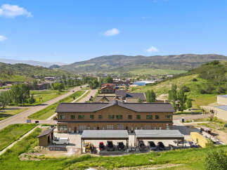 Discover this modern commercial building nestled in a scenic mountain landscape.