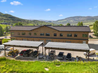 Discover this modern commercial building nestled against a scenic mountain backdrop.