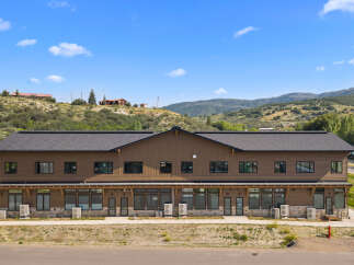Discover this modern commercial building nestled in a scenic mountain landscape.