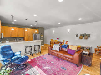 This open-concept living space seamlessly blends a modern kitchen with a comfortable living area, perfect for entertaining.