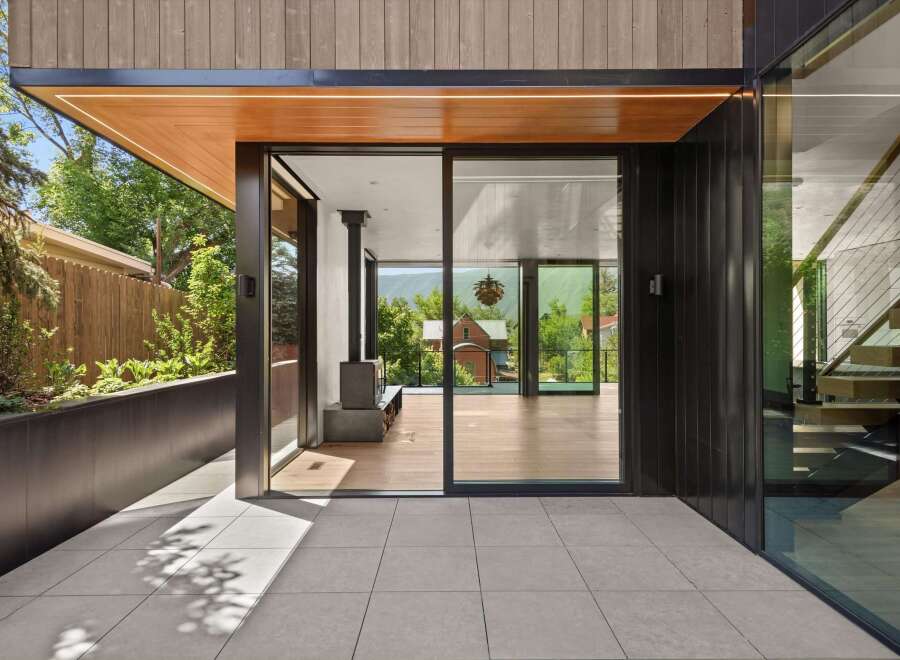 Experience modern living with this stunning architectural home, featuring expansive glass doors that seamlessly blend indoor and outdoor spaces.
