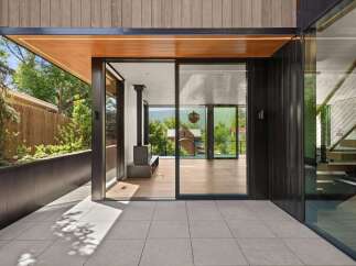 Experience modern living with this stunning architectural home, featuring expansive glass doors that seamlessly blend indoor and outdoor spaces.