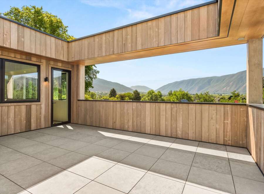 Experience breathtaking mountain views from this expansive modern balcony, perfect for outdoor living and entertaining.