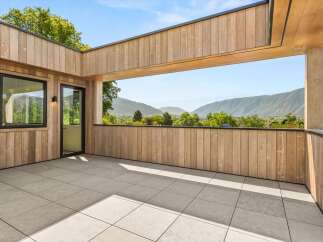 Experience breathtaking mountain views from this expansive modern balcony, perfect for outdoor living and entertaining.
