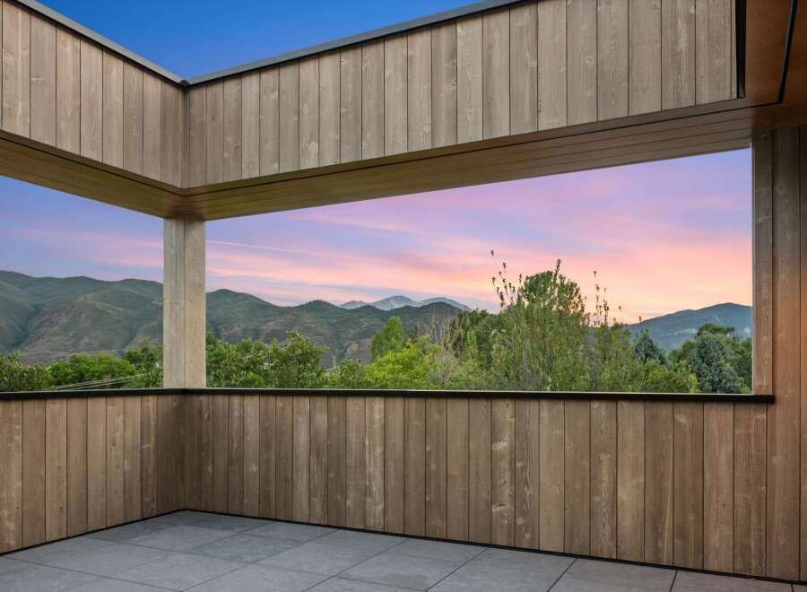 Experience breathtaking sunset views from this modern covered patio, perfect for unwinding or entertaining.