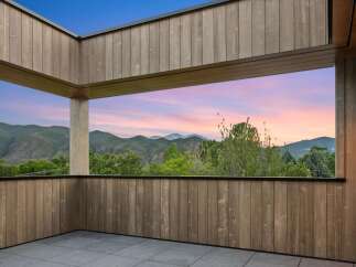 Experience breathtaking sunset views from this modern covered patio, perfect for unwinding or entertaining.