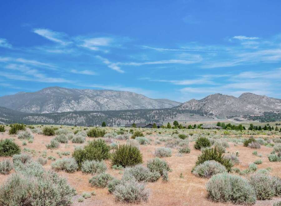 Discover a serene landscape with rolling hills and majestic mountains, perfect for building your dream home.