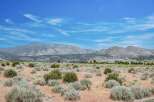 Discover a serene landscape with rolling hills and majestic mountains, perfect for building your dream home.