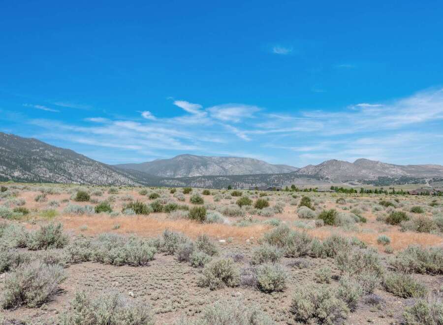 Discover this expansive, undeveloped parcel offering breathtaking panoramic views of the surrounding mountains and vast open skies.