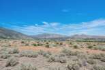 Discover this expansive, undeveloped parcel offering breathtaking panoramic views of the surrounding mountains and vast open skies.