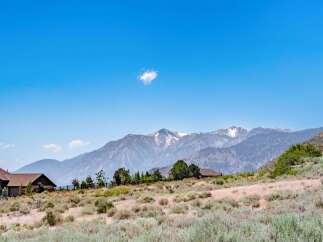 Nestled against a backdrop of majestic snow-capped mountains, this property offers a serene escape with stunning natural beauty.