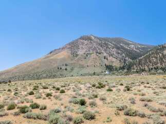 Discover your dream home nestled against a majestic mountain backdrop.