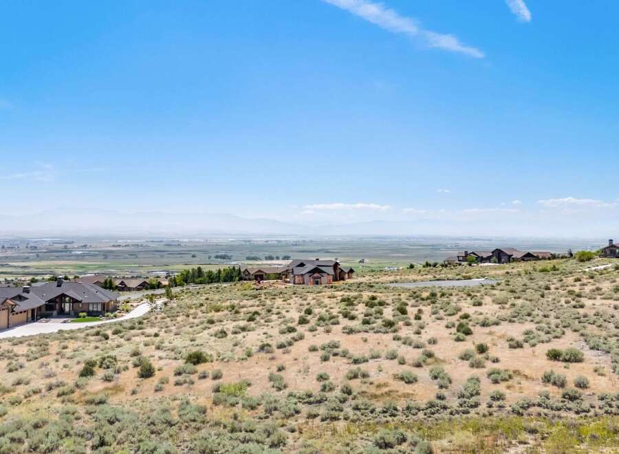 Discover breathtaking panoramic views from this stunning property, offering a serene escape with expansive vistas of the valley and distant mountains.