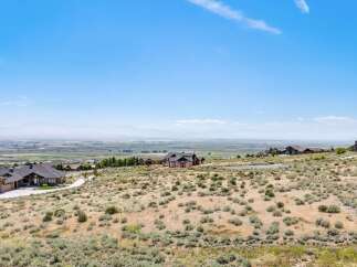 Discover breathtaking panoramic views from this stunning property, offering a serene escape with expansive vistas of the valley and distant mountains.