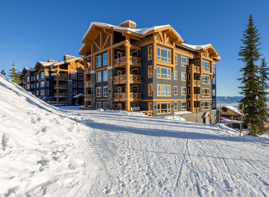Experience luxury mountain living in this stunning ski-in/ski-out condominium complex, perfectly situated on a pristine snowy slope.