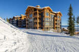 Experience luxury mountain living in this stunning ski-in/ski-out condominium complex, perfectly situated on a pristine snowy slope.