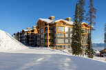 Experience luxury mountain living in this stunning ski-in/ski-out condo, perfectly situated on a pristine snowy slope.
