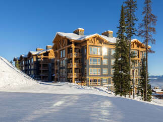 Experience luxury mountain living in this stunning ski-in/ski-out condo, perfectly situated on a pristine snowy slope.