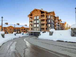 Experience luxury mountain living in this stunning ski-in/ski-out property, featuring a modern alpine design with warm wood accents and stone detailing.