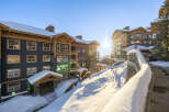 Experience luxury mountain living in this stunning ski resort property, bathed in the warm glow of a winter sun.