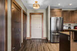 Step into this inviting entryway featuring rich wood doors and a stylish pendant light.