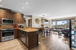Experience modern living in this open-concept space featuring a gourmet kitchen with stainless steel appliances and rich wood cabinetry.