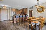 Experience modern living in this stunning condo featuring a gourmet kitchen with stainless steel appliances and a breakfast bar, perfect for casual dining.