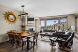 Experience luxury living in this stunning dining and living area, featuring a unique live-edge dining table and a cozy fireplace.