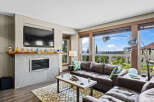 Experience breathtaking mountain views from this stunning living room, featuring a modern fireplace and a luxurious leather sectional.