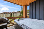 Enjoy ultimate relaxation on this private balcony, complete with a bubbling hot tub and a grill, perfect for outdoor entertaining.