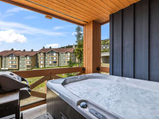 Enjoy ultimate relaxation on this private balcony, complete with a bubbling hot tub and a grill, perfect for outdoor entertaining.