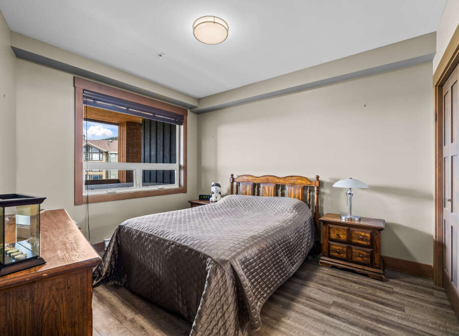 This charming bedroom features a comfortable queen-size bed with a quilted comforter, perfect for a restful night's sleep.