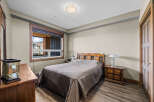 This charming bedroom features a comfortable queen-size bed with a quilted comforter, perfect for a restful night's sleep.
