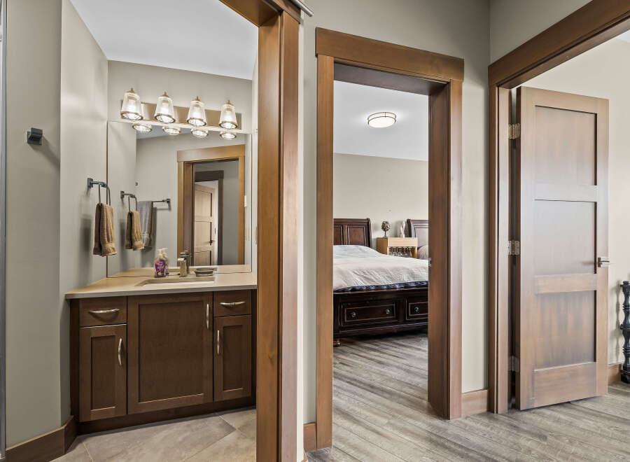 Step into a beautifully appointed bathroom featuring a modern vanity with ample storage and a sleek faucet.