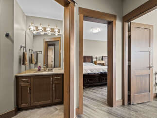 Step into a beautifully appointed bathroom featuring a modern vanity with ample storage and a sleek faucet.