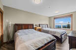 Experience breathtaking mountain views from this spacious bedroom, featuring two comfortable queen-sized beds perfect for families or groups.