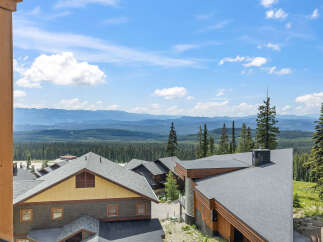 Experience breathtaking mountain views from this stunning property, nestled amidst a lush forest landscape.