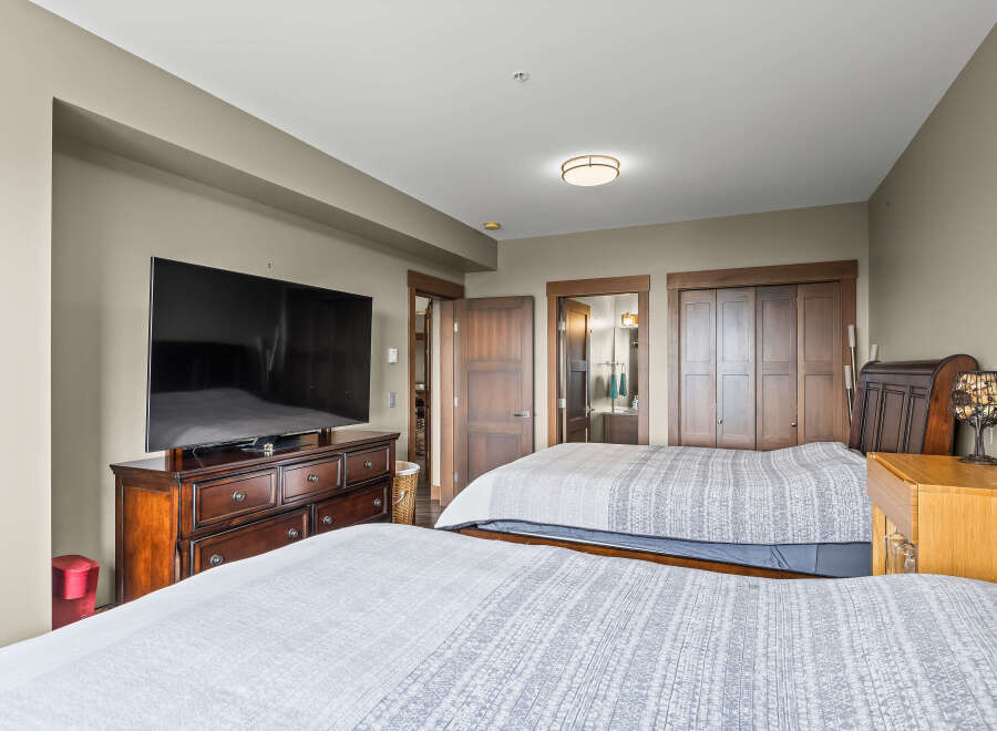 This spacious bedroom features two comfortable queen-sized beds, perfect for families or groups.