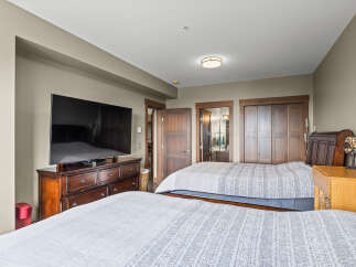 This spacious bedroom features two comfortable queen-sized beds, perfect for families or groups.