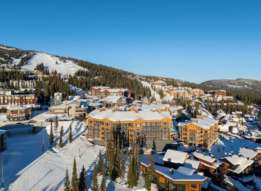 Experience luxury mountain living in this stunning ski resort village, featuring modern architecture and prime slopeside access.