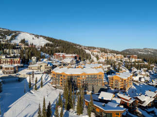Experience luxury mountain living in this stunning ski resort village, featuring modern architecture and prime slopeside access.