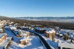 Experience the ultimate mountain lifestyle in this stunning ski resort village, featuring charming architecture and snow-covered rooftops.