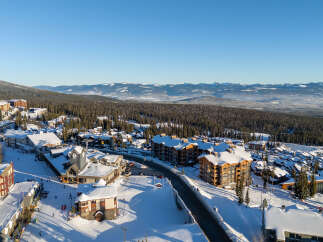 Experience the ultimate mountain lifestyle in this stunning ski resort village, featuring charming architecture and snow-covered rooftops.