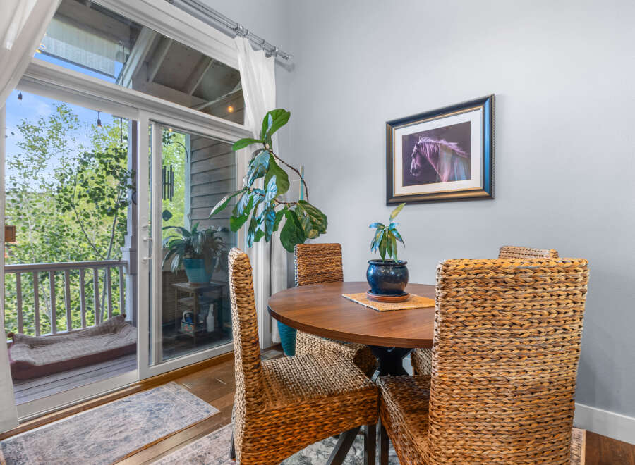 Enjoy your morning coffee or a casual meal in this charming dining nook, bathed in natural light from the adjacent balcony.