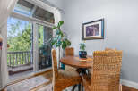 Enjoy your morning coffee or a casual meal in this charming dining nook, bathed in natural light from the adjacent balcony.
