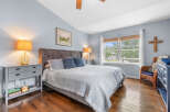 This serene bedroom features a comfortable king-size bed with a plush headboard, complemented by elegant bedside tables and lamps.