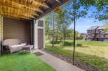 Enjoy outdoor living on this charming patio, complete with a wicker loveseat and coffee table, perfect for relaxing.