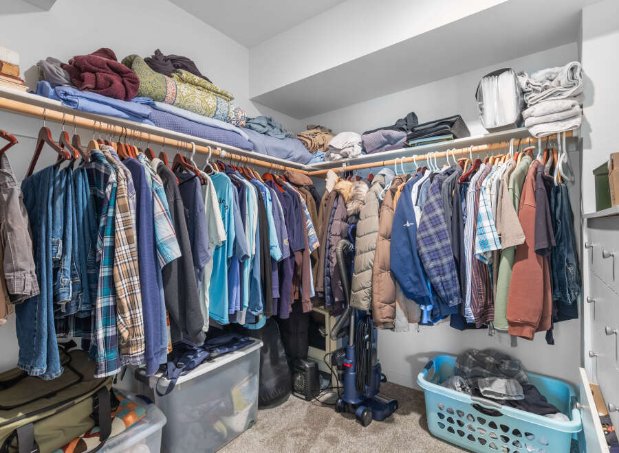Maximize your storage with this spacious walk-in closet, featuring ample shelving and a double-rod hanging system.
