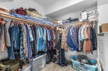 Maximize your storage with this spacious walk-in closet, featuring ample shelving and a double-rod hanging system.